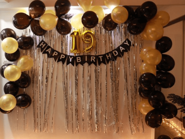 black and yellow balloons decoration idea for 19 year old birthday